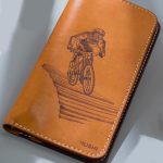 Imported genuine long leather wallet in beige with bicycle rider painting in Pakistan.