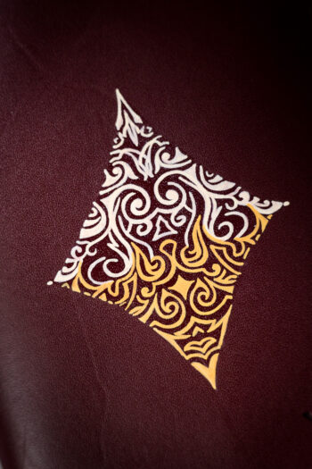 Burgundy vegetable-tanned leather with a diamond abstract design.