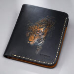 Genuine minimalist leather wallet with pull-out strap in black with fierce leopard painting in Pakistan.