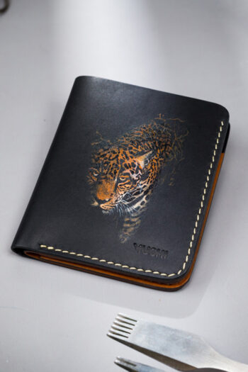 Genuine minimalist leather wallet with pull-out strap in black with fierce leopard painting in Pakistan.