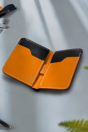 Genuine minimalist leather wallet with pull-out strap in black with fierce leopard painting in Pakistan.