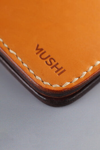 Genuine minimalist leather wallet with pull-out strap in beige with hawk painting in Pakistan.