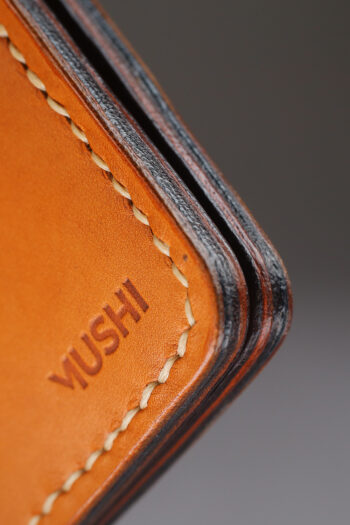 Genuine minimalist leather wallet with pull-out strap in beige with hawk painting in Pakistan.