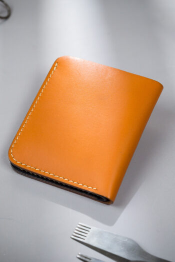 Genuine minimalist leather wallet with pull-out strap in beige with hawk painting in Pakistan.