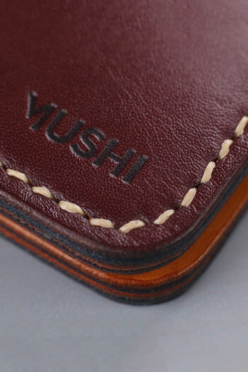 Imported genuine long leather wallet in burgundy with green parrot painting in Pakistan.
