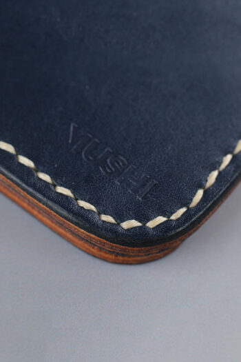Navy vegetable-tanned leather with a spade abstract design.