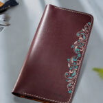 Handcrafted burgundy leather wallet with traditional motif art by MUSHI for women.