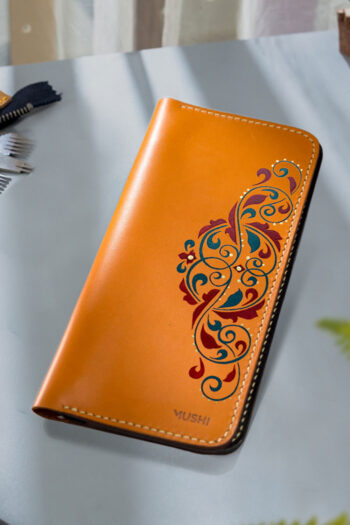Hand-painted leather wallet with cultural design for women in Pakistan.