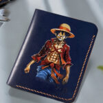 Hand-painted Monkey D. Luffy artwork on handcrafted leather wallet by MUSHI for anime fans.