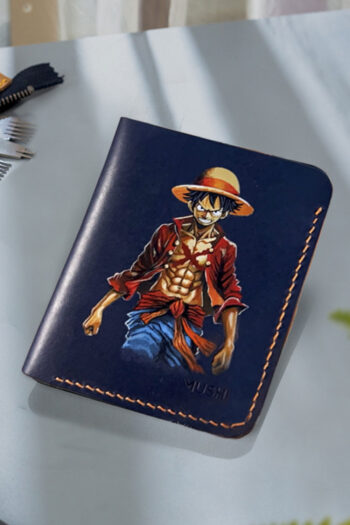 Hand-painted Monkey D. Luffy artwork on handcrafted leather wallet by MUSHI for anime fans.