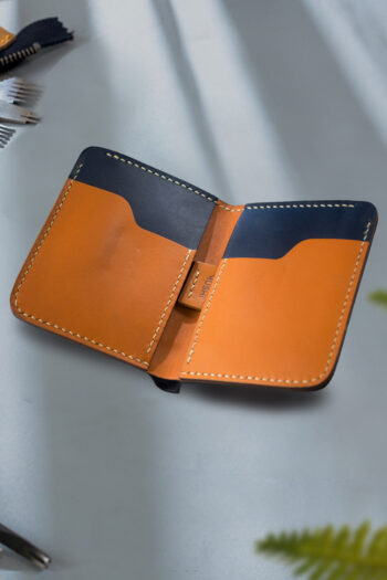 Handmade orange and black Leather Wallet stitching by Hands