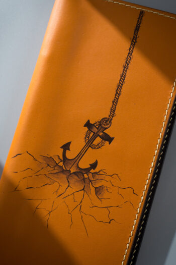 Creative Art on MUSHI Wallet in Pakistan featuring Sea Anchor Concept when submerged in Ocean Cracking the Earth surface.