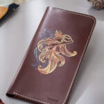 Burgundy long leather wallet with abstract fish art, hand-painted minimalist design
