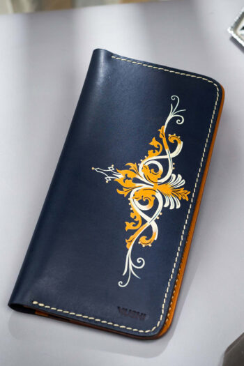 Designer leather wallet gift with golden abstract swirls on dark blue leather